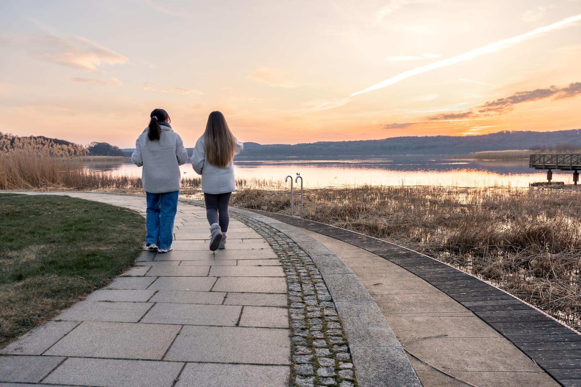Person walking outdoors on a paved path